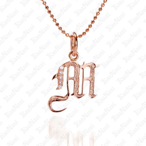 The picture shows a 14K rose gold Koa Nani M initial pendant.