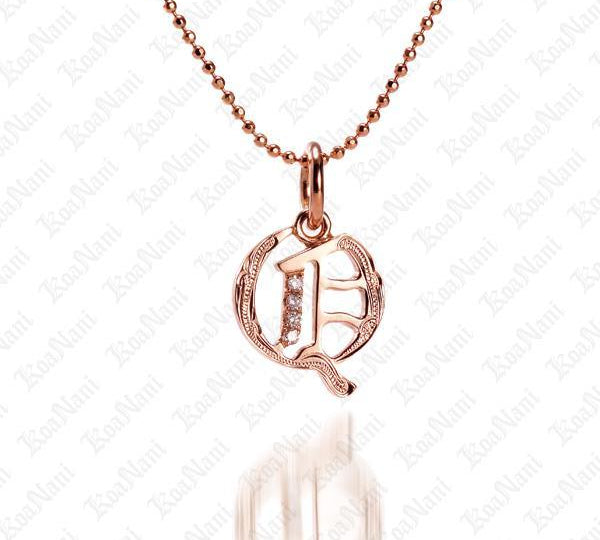 The picture shows a 14K rose gold Koa Nani Q initial pendant.
