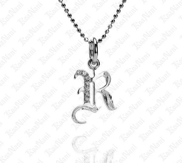 The picture shows a 14K white gold Koa Nani R initial pendant.