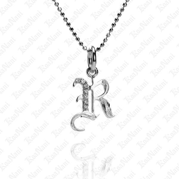The picture shows a 14K white gold Koa Nani R initial pendant.