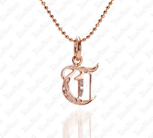 The picture shows a 14K rose gold Koa Nani T initial pendant.