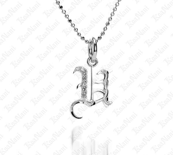 The picture shows a 14K white gold Koa Nani U initial pendant.