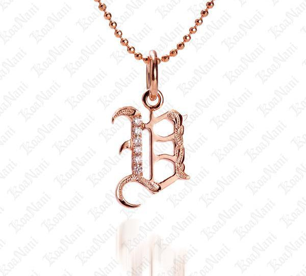 The picture shows a 14K rose gold Koa Nani V initial pendant.