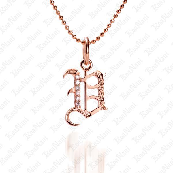 The picture shows a 14K rose gold Koa Nani V initial pendant.