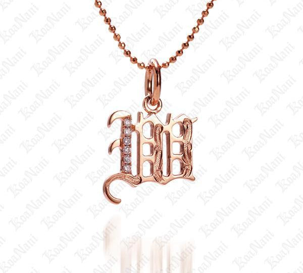 The picture shows a 14K rose gold Koa Nani W initial pendant.