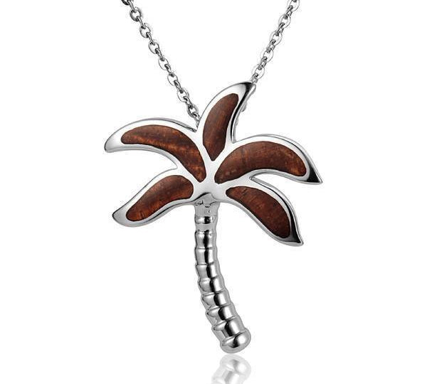 In this photo there is a large sterling silver and koa wood palm tree pendant.