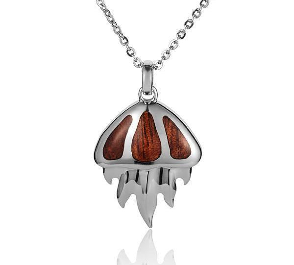 In this photo there is a sterling silver and koa wood jellyfish pendant.
