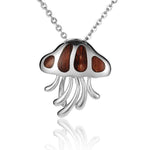 In this photo there is a sterling silver and koa wood jellyfish pendant.