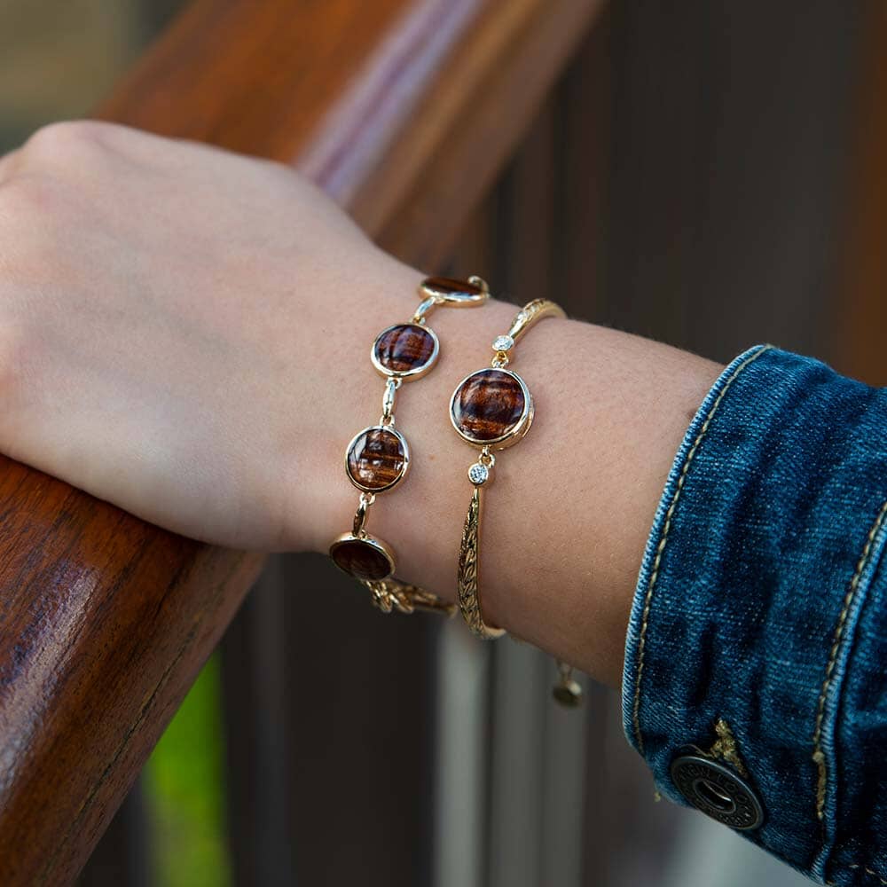 14K gold bracelet featuring a Koa wood centerpiece with two diamonds on the sides. 