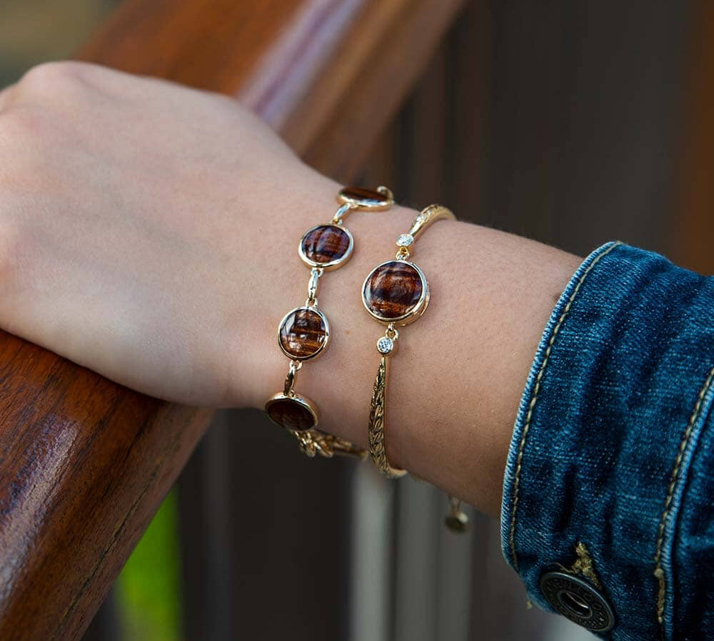 14K gold bracelet featuring a Koa wood centerpiece with two diamonds on the sides. 