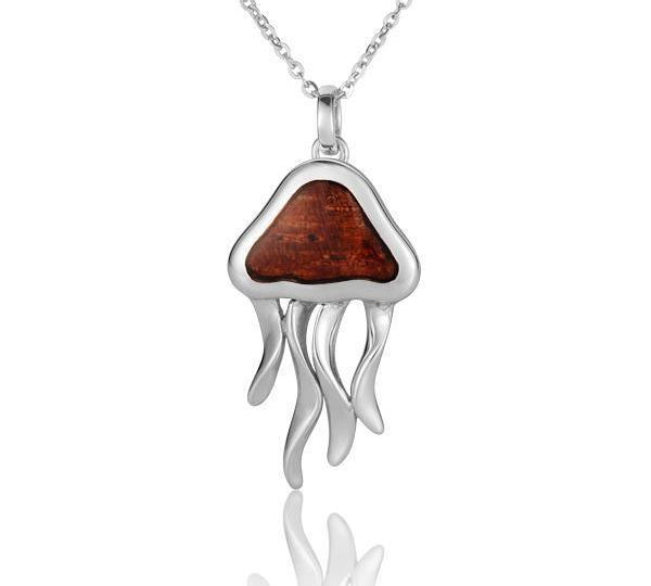 In this photo there is a sterling silver and koa wood jellyfish pendant.