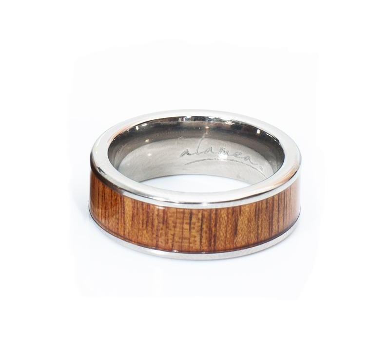 In this photo there is a ring made of koa wood and titanium.