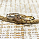 The picture shows a 14K white gold, yellow, and rose gold, tri-color rings. The rose gold heart ring features diamonds.