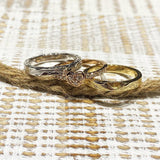 The picture shows a 14K white gold, yellow, and rose gold, tri-color rings. The rose gold heart ring features diamonds.