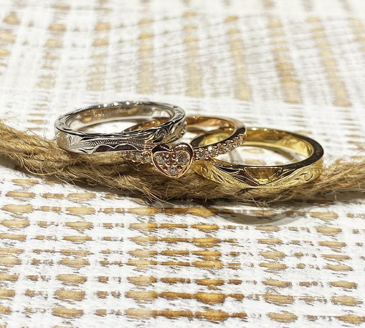 The picture shows a 14K white gold, yellow, and rose gold, tri-color rings. The rose gold heart ring features diamonds.