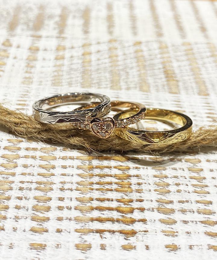The picture shows a 14K white gold, yellow, and rose gold, tri-color rings. The rose gold heart ring features diamonds.