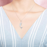 The picture shows a model wearing a 925 sterling silver mermaid pendant and a blue shirt with blue lines.