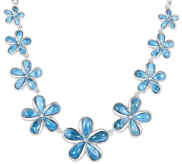 In this photo there is a sterling silver plumeria necklace with nine plumeria flowers and blue larimar gemstones.