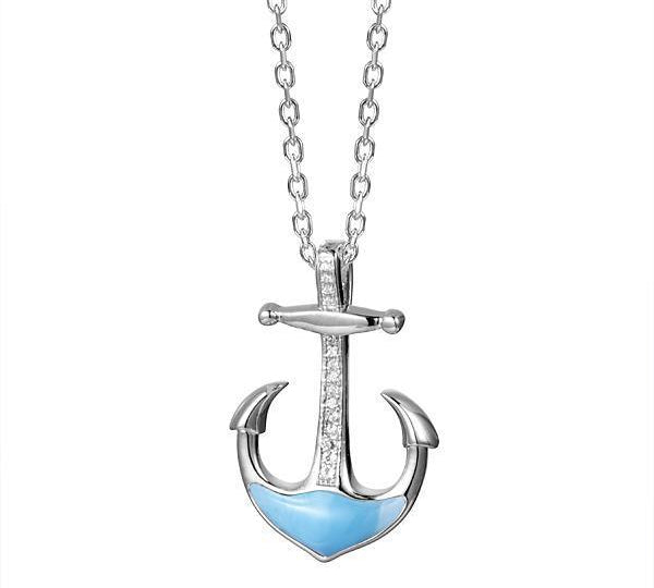 In this photo there is a sterling silver anchor pendant with blue larimar and topaz gemstones.