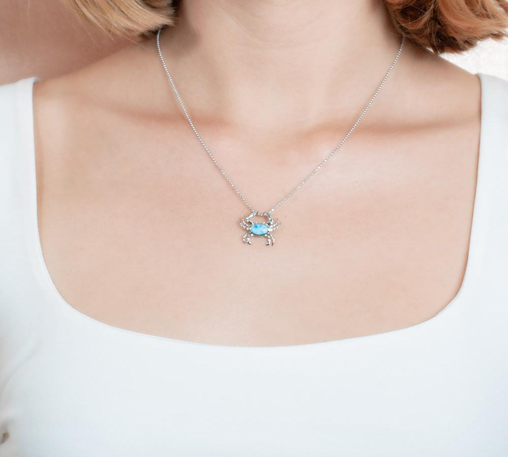 The picture shows a 925 sterling silver larimar blue crab pendant.