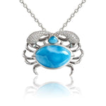 The picture shows a 925 sterling silver blue crab treasure pendant  with hand-selected larimar gemstones and topaz.