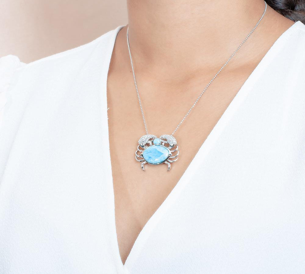 The picture shows a model wearing a 925 sterling silver larimar blue crab treasure pendant.