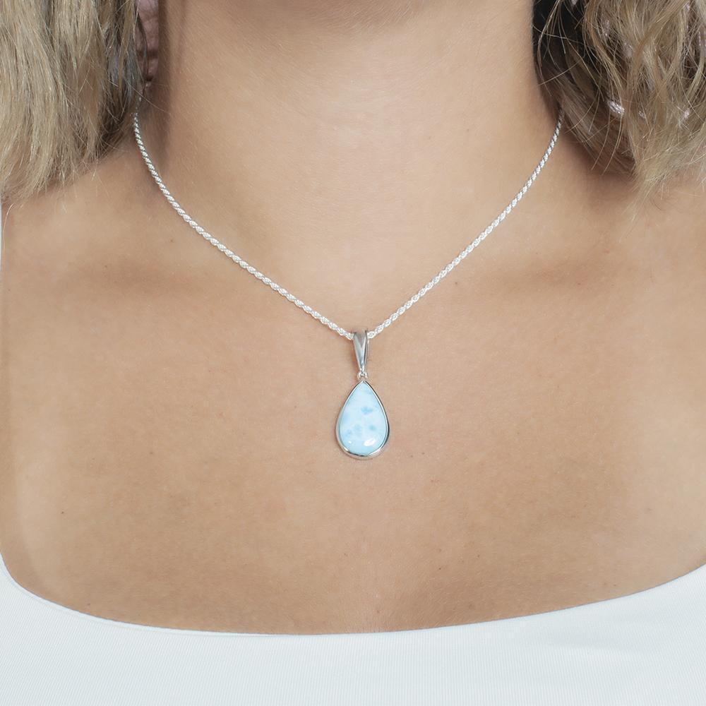 The picture shows a model wearing a 925 sterling silver larimar teardrop pendant.
