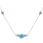 The picture shows a 14K white gold necklace with three larimar gemstones paired with diamonds and two aquamarine gemstones.