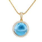 The picture shows a 14K yellow gold larimar circle pendant with diamonds.