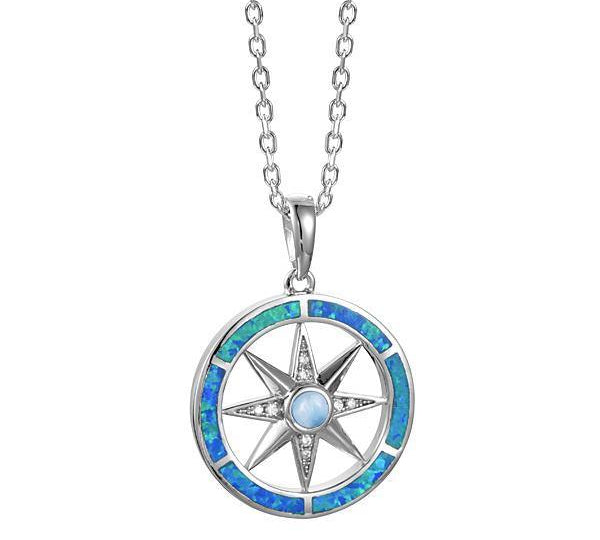 In this photo there is a sterling silver compass pendant with blue larimar, blue opalite, and topaz gemstones.