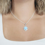 The picture shows a model wearing a 925 sterling silver larimar mandorla pendant.