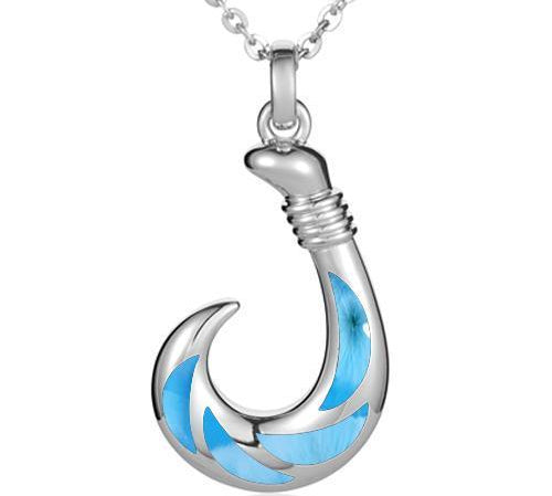 In this photo there is a sterling silver fish hook pendant with blue larimar gemstones.