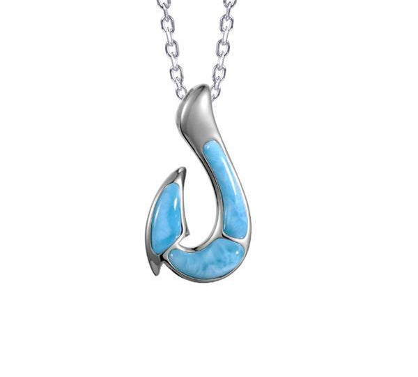 In this photo there is a sterling silver fish hook pendant with blue larimar gemstones.