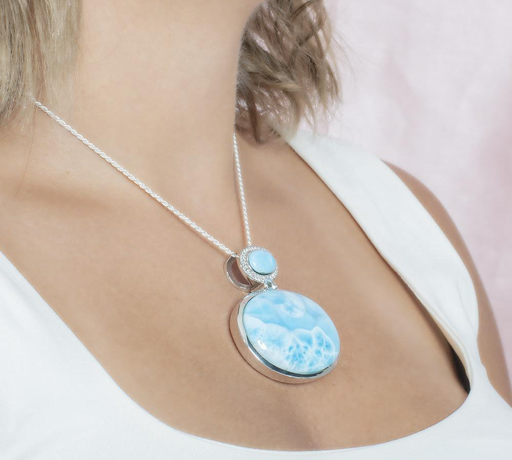 The picture shows a model wearing a 925 sterling silver larimar pendant.