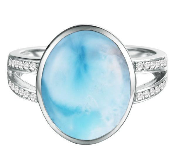 The picture shows a 14K white gold larimar cocktail ring with a split band lined with diamonds and topaz gemstones