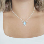 The picture shows a model wearing a 925 sterling silver larimar honu pendant.