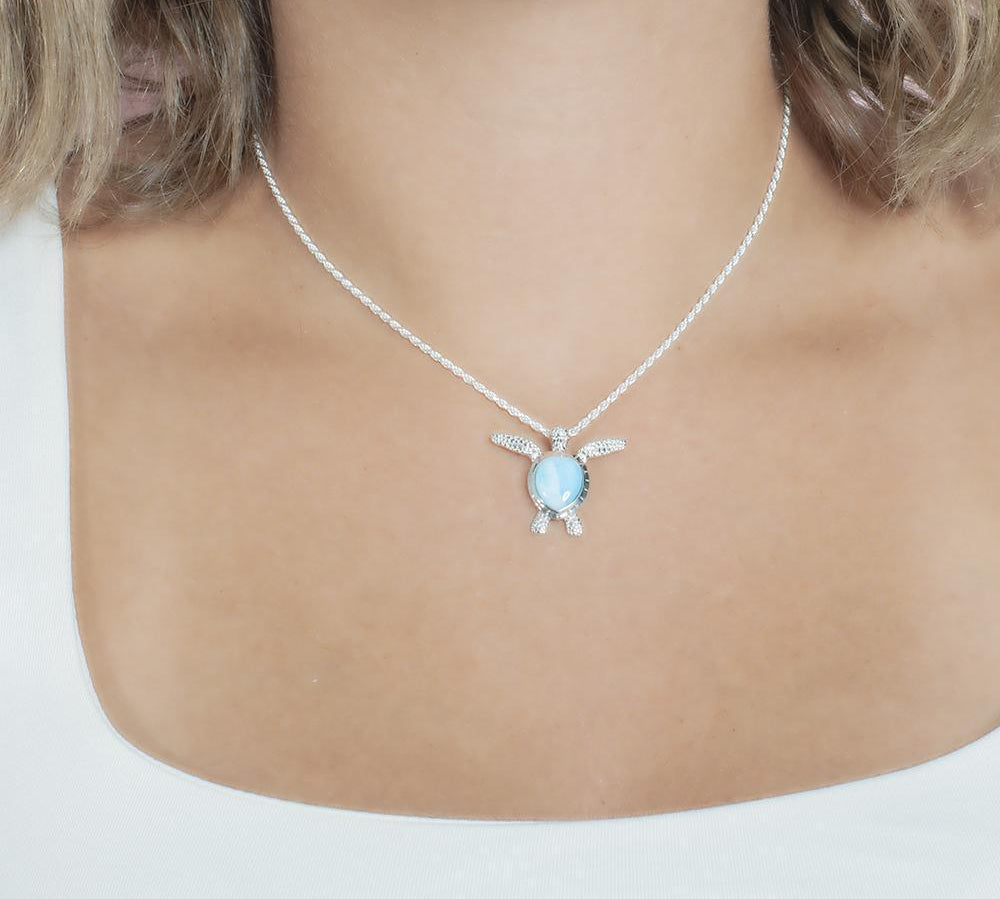The picture shows a model wearing a 925 sterling silver larimar honu pendant.