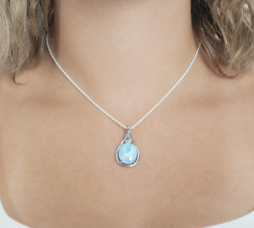 The picture shows a model wearing a 925 sterling silver larimar hidden gem pendant.
