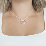 The picture shows a model wearing a 925 sterling silver larimar high tide pendant.