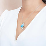 The picture shows a model wearing a 925 sterling silver larimar sea turtle pendant.