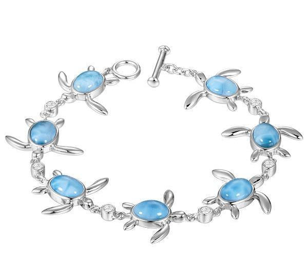 The picture shows a 925 sterling silver sea turtle charm bracelet with larimar gemstones and cubic zirconia.