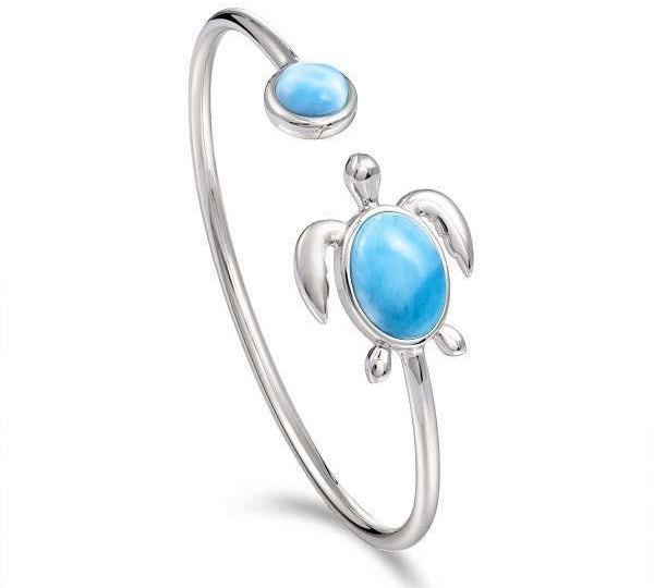 The picture shows a 925 sterling silver sea turtle bangle bracelet with two larimar gemstones.