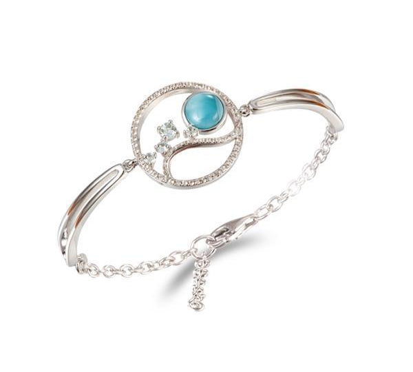 In this photo there is a 925 sterling silver bracelet with larimar, topaz, and aquamarine gemstones.