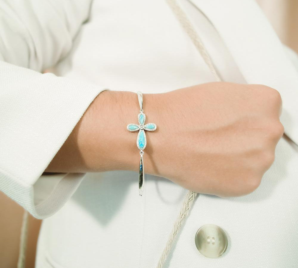 The picture shows a 925 sterling silver larimar cross bracelet and topaz.