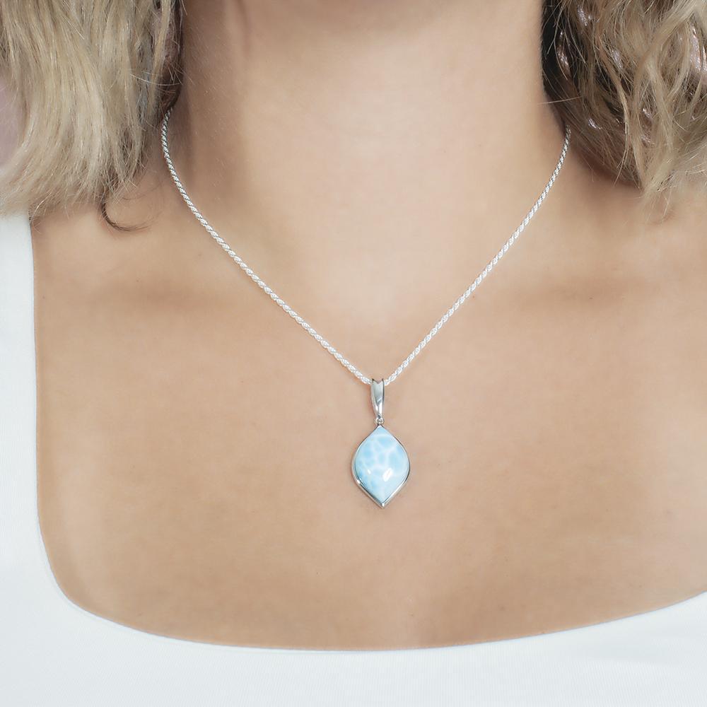 The picture shows a model wearing a 925 sterling silver larimar loa mandorla pendant.