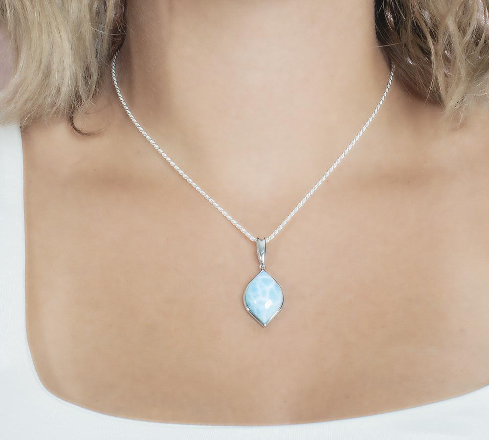 The picture shows a model wearing a 925 sterling silver larimar loa mandorla pendant.