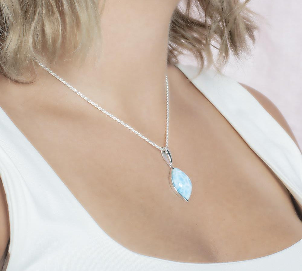 The picture shows a model wearing a 925 sterling silver larimar loa mandorla pendant.