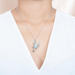 The picture shows a model wearing a 925 sterling silver larimar lobster pendant.