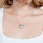 The picture shows a model wearing a 925 sterling silver larimar lucky blue crab pendant.