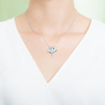 The picture shows a model wearing a 925 sterling silver larimar manta ray pendant.